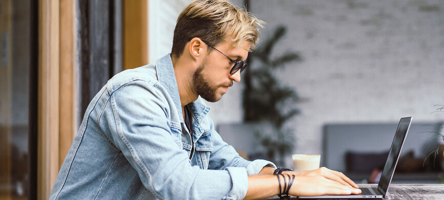 Man using a laptop, illustrating FINcredible analytics and data intelligence services.