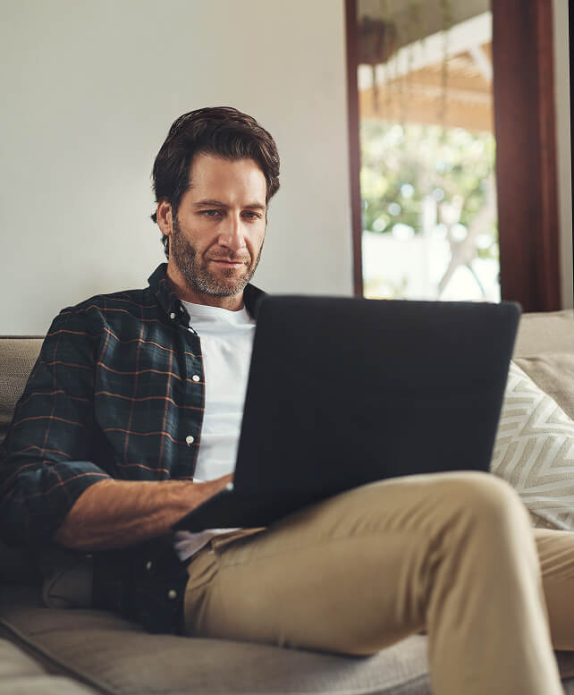 Man using a laptop at home, representing FINcredible integration support services.