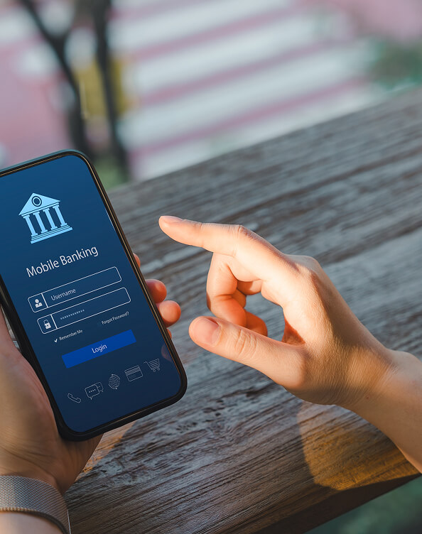 Hands using a smartphone to sign in to mobile banking, illustrating secure bank account access.