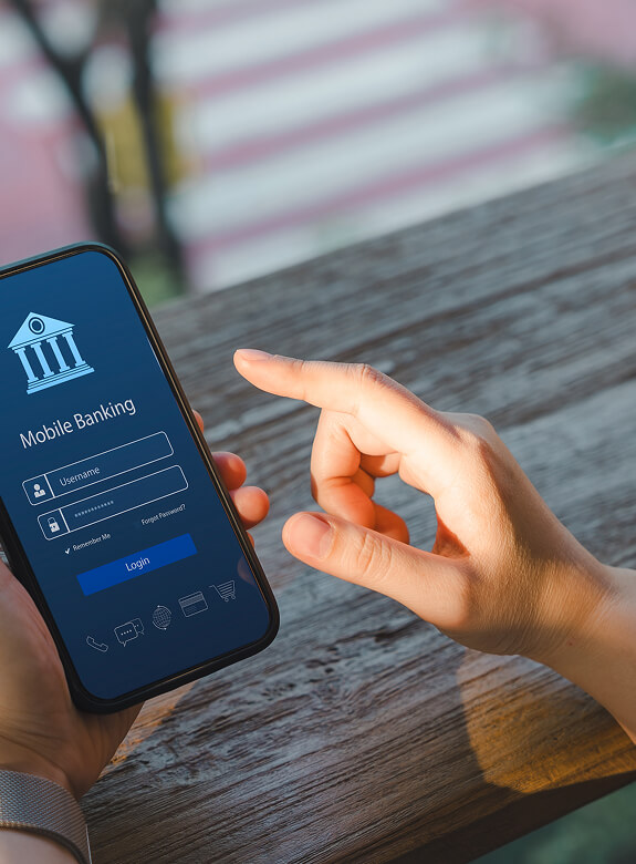 Person signing in to mobile banking on a smartphone, illustrating secure open banking access.