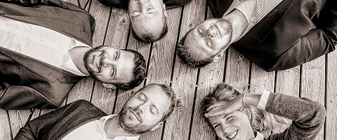 Black-and-white overhead photograph of the FINcredible founding team in 2017.