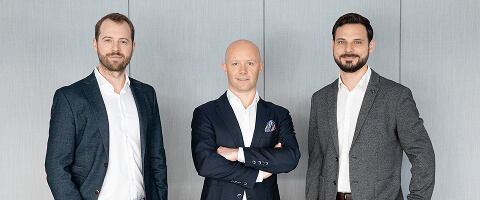 Three business leaders in suits representing FINcredible's 2022 company milestone.
